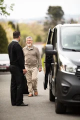 Senior man getting picked-up for his airport transfer by a private shuttle service driver. Commericial trasfer cargo transportation company fleet. Vip charter © lightpoet