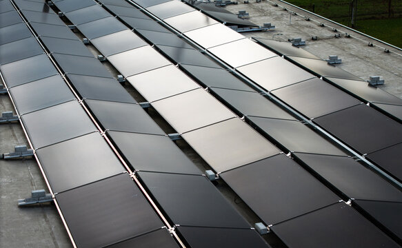 Photovoltaic Solar Panel Installation on Industrial Flat Roof for Sustainable Energy Production