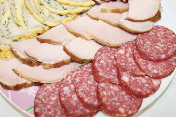 Assorted cold cuts arranged beautifully on a platter ready for a gathering or celebration