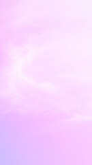 Sky background with soft wispy clouds against a dreamy vertical pastel gradient of pink, lilac, and pale blue with significant empty space for text concept, weather and nature, clean template