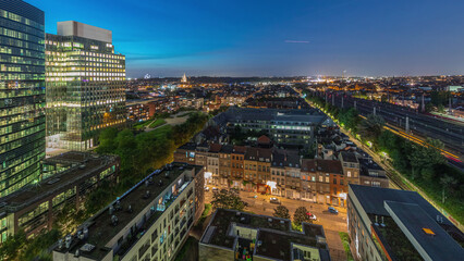 Fototapeta premium Aerial day to night timelapse of Brussels urban landscape blending office skyscrapers with residential areas.