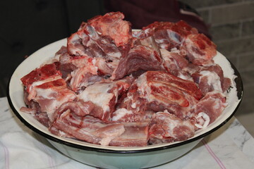 Freshly cut meat in a large bowl ready for cooking and meal preparation at home kitchen