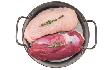 Plucked duck fillets presented with herbs in rustic pan over white background great for gourmet recipes cooking preparation stock content.