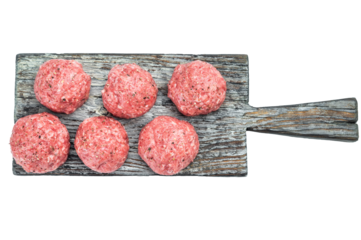 Fresh raw meatballs made from ground beef with seasoning on rustic wooden board over white background ideal for cooking and protein themes.