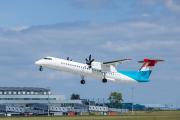 Turboprop airplane taking off from airport runway
