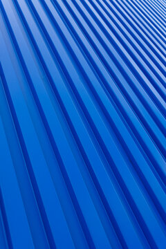 Blue building zinc wall backdrop,Corrugated metal sheet wall. Background of blue corrugated steel sheets with diagonal corrugations as wall of modern building with copy space. Selective focus