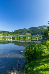 Fototapeta premium Green railway bridge crossing Vah river in Strecno, Slovakia