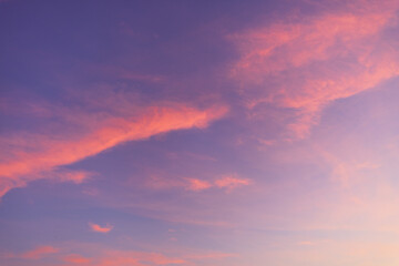 Fototapeta premium Sky and clouds during twilight of the day,Aerial view dramatic sunset and sunrise sky nature background with white clouds,A beautiful sky tinted by the sun leaving vibrant shades of gold, pink,