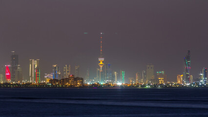 Skyline with Skyscrapers day to night timelapse in Kuwait City downtown illuminated at dusk. Kuwait City, Middle East