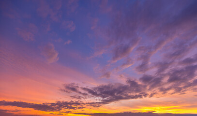 Sky and clouds during twilight of the day,Aerial view dramatic sunset and sunrise sky nature background with white clouds,A beautiful sky tinted by the sun leaving vibrant shades of gold, pink,
