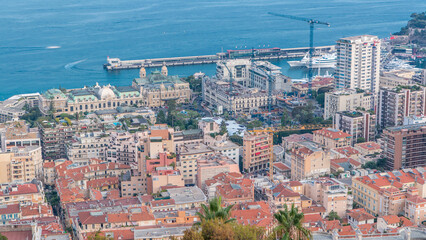 Cityscape timelapse of Monte Carlo, Monaco with roofs of buildings during summer sunset.