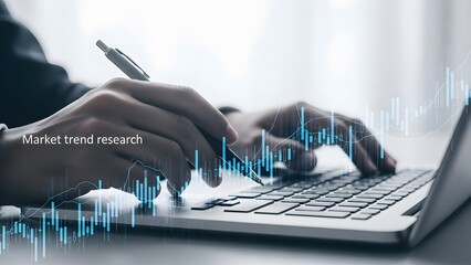 Analyzing financial data on laptop with pen in hand and blue graph overlay for business growth