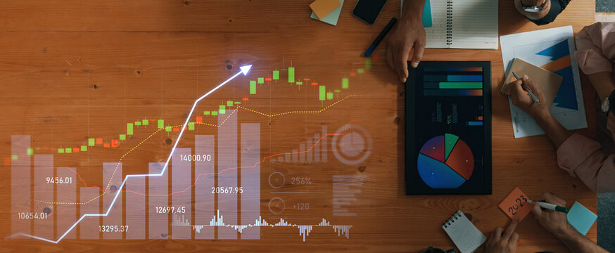 Team collaborates over a wooden table, analyzing financial data with charts and graphs, reflecting market trends and performance metrics for informed decision-making. Scalp - Powered by Adobe