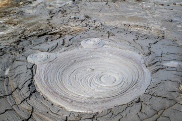 Thick bubbling mud fills the crater of a small mud volcano in Qobustan, Azerbaijan.