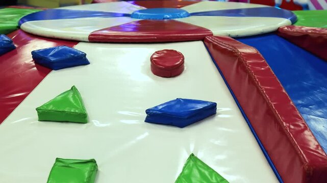 Colorful soft climbing structure in an indoor playground, Soft play indoor equipment with padded climbing blocks, ideal for kids activity, safety, and developmental or recreational content