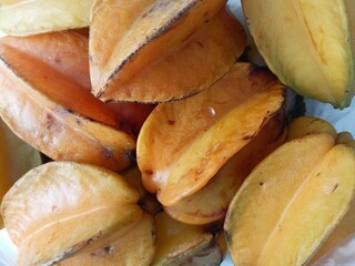 Close-up of ripe and overripe starfruit showing natural spots and aging texture