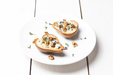 Baked pear with blue cheese, honey, and nuts. Healthy eating. Vegetarian food.