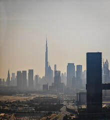 Naklejka premium Dubai Downtown and Business bay in the distance. Aerial drone view of Dubai panorama in dusk and sandstorm dust