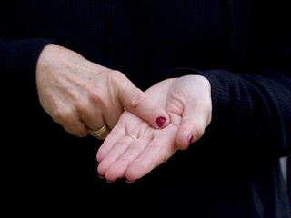 A pair of hands signing the consonant letter 'L' in British Sign Language.BSL.Communication.Hearing Impaired