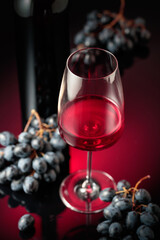 Red wine and juicy blue grapes.