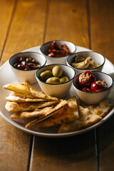 Mediterranean antipasto platter with pita, olives and marinated vegetables