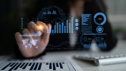 A business professional interacts with digital data visuals, showcasing trends and analytics while working in an office environment to drive informed decisions. Scalp