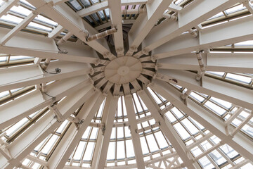 The photograph displays the interior structure of a large architectural dome or cupola. Industrial