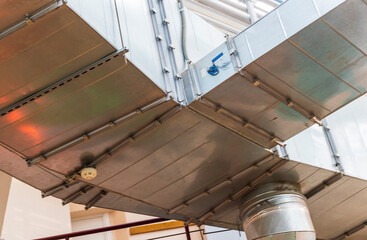 The photograph displays an industrial ventilation system. Industrial