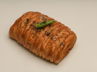 Danish pastry with savory filling on white background