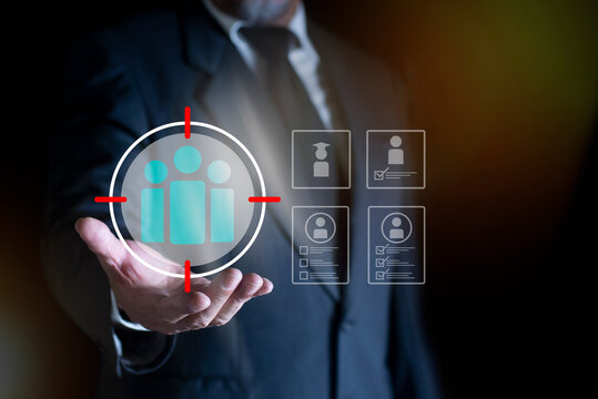 HR management concept, Businessman holding virtual human icon for resources within an organization, focusing on recruitment, training, and fostering a productive organizational culture.