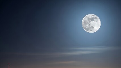 Obraz premium Stunning Full Moon Rising Over Misty Horizon – Clear Night Sky with Detailed Lunar Craters and Soft Clouds