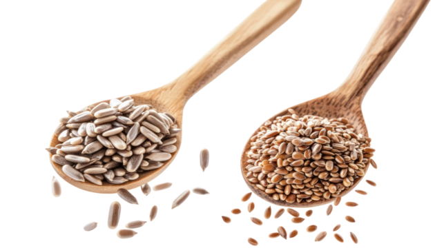 Two piles of sunflower seeds and flax seeds falling in the air on transparent background