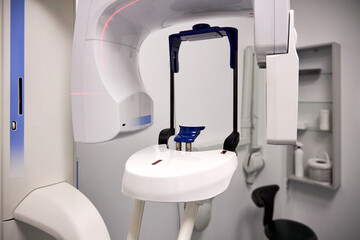 Modern panoramic dental X ray machine diagnostics in dentistry. CBCT Cone Beam Computed Tomography medical technique uses cone shaped X ray beam to create 3D images of teeth, jaw, nerves and sinuses.