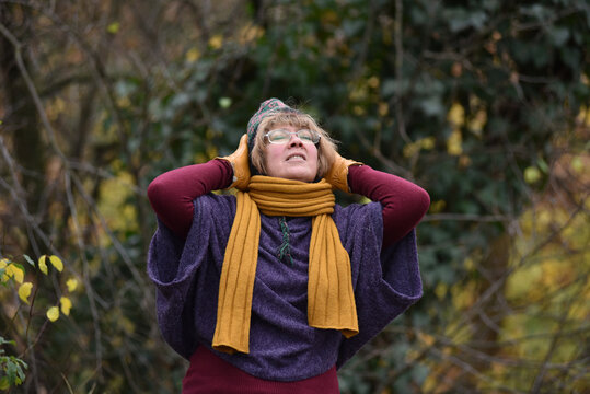 Woman looking up at the sky in an autumn park
