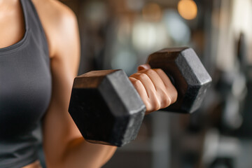 Close-up of a woman's hand holding a dumbbell in a gym, with a close-up on her arm and shoulder muscle. Ai generated
