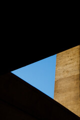 Sharp architectural shadows framing blue sky
