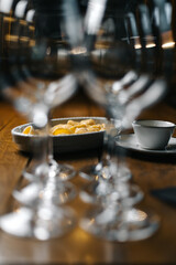 Creamy Italian pasta on wooden table with wine glasses in foreground