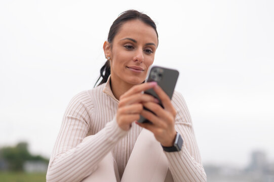 Woman scrolling phone, browsing social media, or texting
