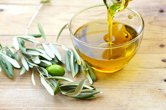 Pouring olive oil into a glass bowl