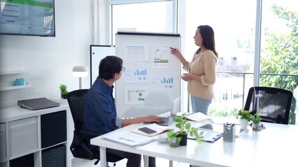 Asian business professionals analyze market data during office meeting presenting financial reports collaborate on project strategy for company growth success - Powered by Adobe