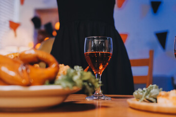 Joyful office Halloween party with coworkers in costumes, celebrating with drinks and laughter, fostering teamwork and festive spirit