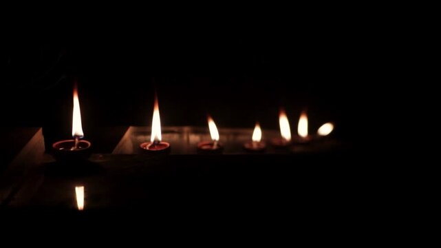 Indian festival diwali night burning oil lamp for diya.
diya panti candels in inda for god in temple.
Decorative colourful Traditional diya lamp lit during celebration. Outdoor