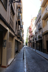 Narrow city street in Granada, Andalusia, Spain, photographed in July 2024.