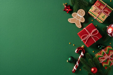 Obraz premium Vibrant green background with wrapped gifts, gingerbread, candy cane and pine accents. Festive ornaments create a warm holiday mood