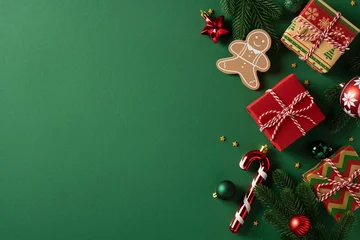Fototapeten Pony Vibrant green background with wrapped gifts, gingerbread, candy cane and pine accents. Festive ornaments create a warm holiday mood  © ActionGP