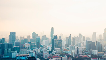 Fototapeta premium Aerial view of modern city skyline covered with smog and haze, indicating air pollution and PM2.5 problem. Useful for environmental, climate crisis, urban health, and air quality awareness content.