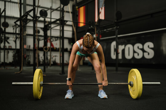 Woman preparing a deadlift in gym for strength training