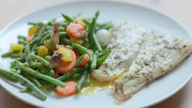 Baked Cod Fish Fillet Served with Steamed Green Vegetables