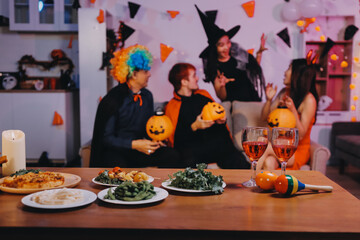 Joyful office Halloween party with coworkers in costumes, celebrating with drinks and laughter, fostering teamwork and festive spirit