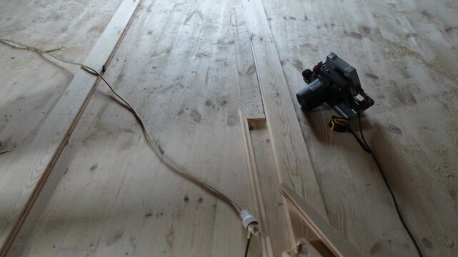 Preparing wooden planks for installation. Tools and workspace during real construction
